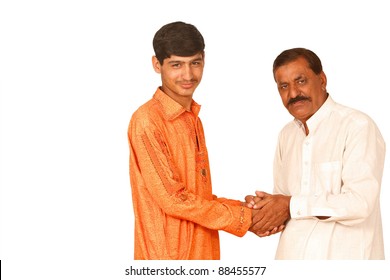 Indian Teenager Shaking Hands With Old Man