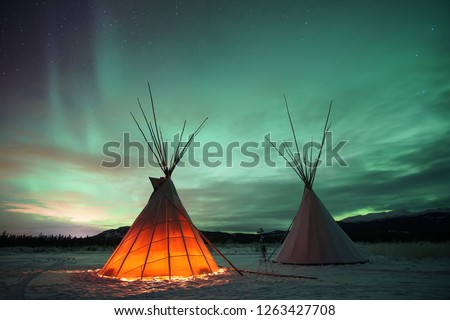 Indian Tipies under the northern lights in Whitehorse, Yukon (Canada)