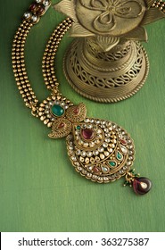 Indian Traditional Designer Jewellery Over Green Background , Selective Focus