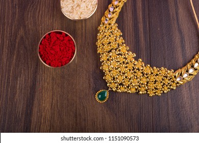 Indian Traditional Gold Jewellery Necklace with kumkum and grain rice.