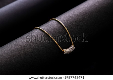 Indian traditional jewellery, close up of pendent on dark background 