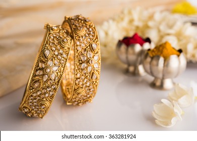 Indian traditional wedding jewellery, bangles with huldi kumkum and white flowers. selective focus - Shutterstock ID 363281924