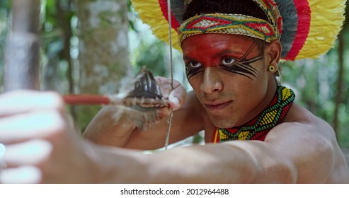 Indian From The Pataxó Tribe Using A Bow And Arrow. Indian's Day. Brazilian Indian