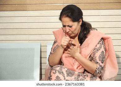 Indian unhealthy female patient at hospital. Mature unhappy women caught cold, suffering from cough. Medical insurance, healthcare concept. - Shutterstock ID 2367163381