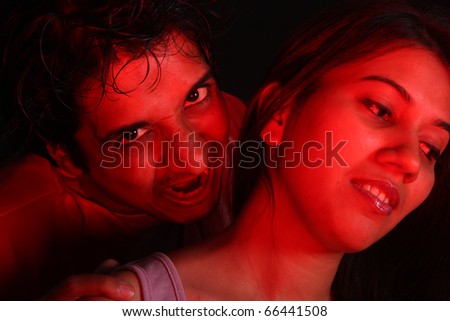 An Indian vampire about to bite a beautiful woman for blood.