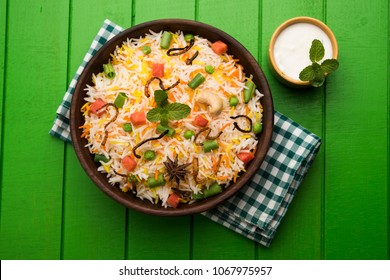 Indian Vegetable Pulav or Biryani made using Basmati Rice, served in terracotta bowl. selective focus
