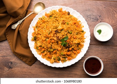 Indian Vegetable Pulav or Biryani made using Basmati Rice, served in terracotta bowl. selective focus