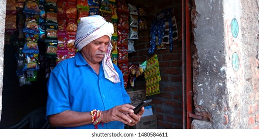 An Indian Village Greengrocer Operating Smart Phone At Store District Katni Madhya Pradesh In India Shot Captured On Aug 2019