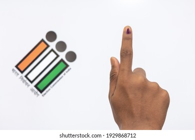Indian Voter Hand with voting sign and ink pointing vote for India behind on election commission of India background.