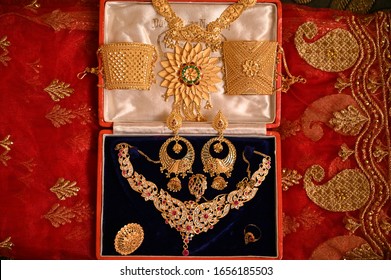 Indian Wedding Bridal Jewellery On Red Cloth , Gold Jewellery For Bride.