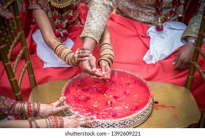 Indian Wedding Traditional Game Ritual Ceremony Bride And Groom Searching For Ring In Plate