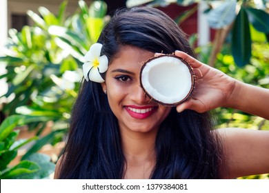 Indian Woman Applying Coconut Oil Dark Brunette Long Hair In A Hand On Green Summer Park Nature Tropical