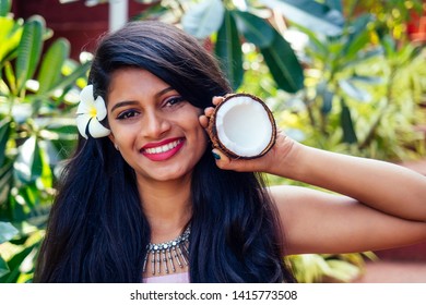 Indian Woman Applying Coconut Oil Dark Brunette Long Hair In A Hand On Green Summer Park Nature Tropical