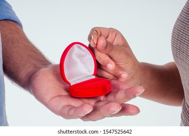 Indian Woman Asking Her Boyfriend To Get Wedding Studio White Background.red Gift Ring Box Heard Shape