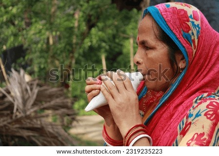 Indian woman blows the conch
