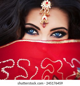 Indian woman bride wedding makeup, beautiful girl traditional sari costume covered face with veil,  Female bollywood dancer. Arabian bellydancer