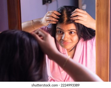 An Indian Woman Checks Hair Loss Problem In Front Of Mirror