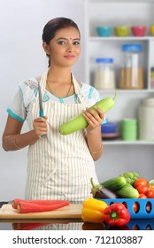 Indian Woman Cooking In Kitchen