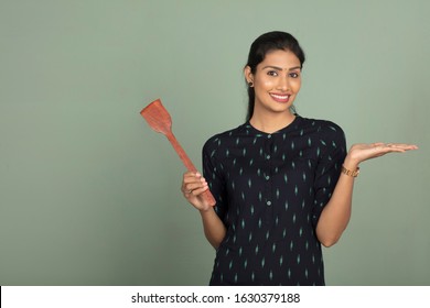 Indian Woman With Cooking Pan Stick, Indoor Shot