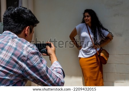 Similar – Männerhände fotografieren zwei glückliche Frauen im Freien.