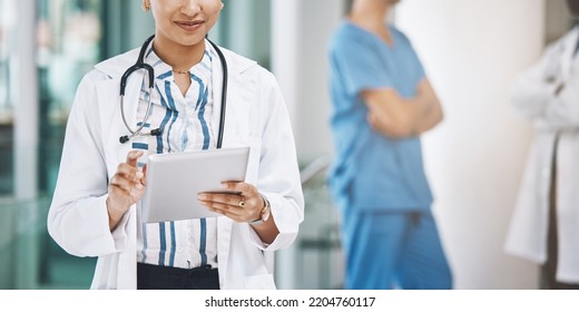 Indian Woman Doctor With Tablet For Medical Data In Digital Online Web Medicine, Innovation Tech And Medicare App Research. Healthcare Lady On Mobile Internet Or Site For Health Lab Exam Test Results