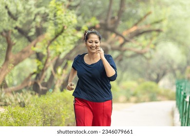 Indian woman doing jogging at park. - Powered by Shutterstock