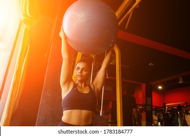 Indian Woman Doing Pilates And Balance Exercises Gymnastic Ball