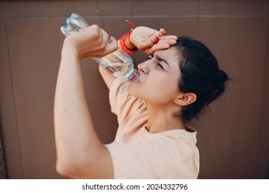 Indian Woman Drinking Bottled Still Water Outdoor Wall. Extreme Heat Concept.