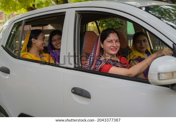 Indian woman driving car at\
village