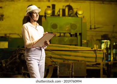 Indian Woman Industrial Engineer Holding Notepad Wearing White Helmet At Factory . Copy Space. Skill India And Women Empowerment Concept.  Copy Space. 