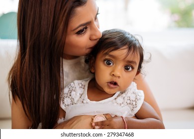 Indian Woman Kissing Her Adorable Baby Girl