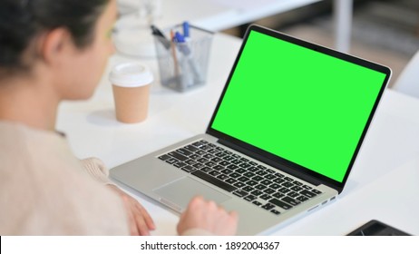 Indian Woman Looking At Laptop With Green Chroma Key Screen