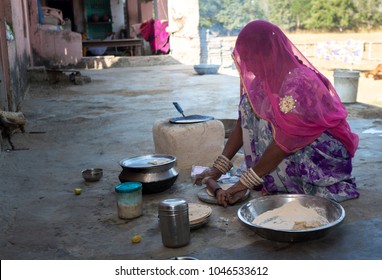 An Indian Woman Making Food For Family In Rajasthan, India