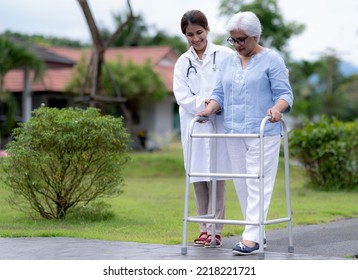 Indian woman nursing home worker caring for elderly woman walking with walking aid, nursing care. - Powered by Shutterstock