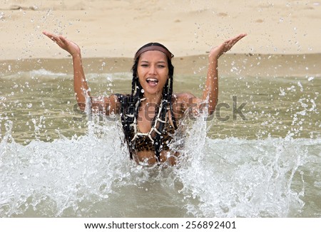 Indian woman playful in the sea