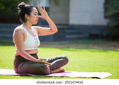 Indian woman practicing yoga at home