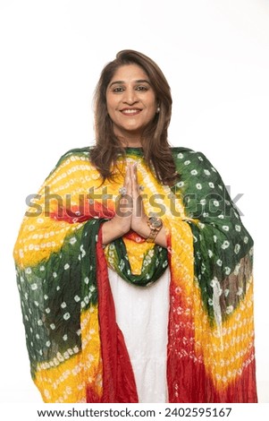 Indian woman praying with hands together or namaste on white background