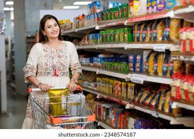 Indian woman purchasing at grocery store. - Powered by Shutterstock