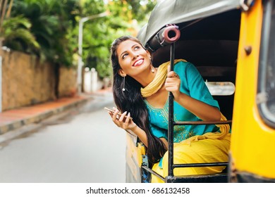 Indian Woman In Rickshaw Holding Mobile Phone