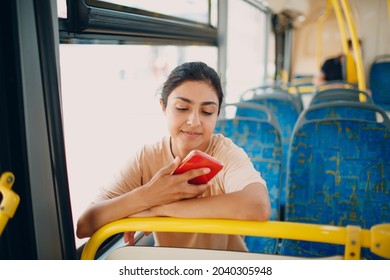 Indian Woman ride in public transport bus using mobile phone - Powered by Shutterstock