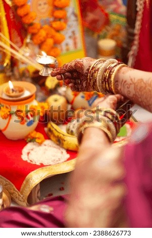 An Indian woman is seen performing aarti, which is a Hindu religious ritual. Indian Hindu puja background.