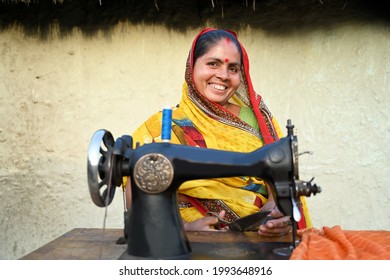 An Indian woman sewing clothes using sewing maching