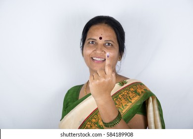 A indian woman show her ink-marked fingers after casting vote in election.
