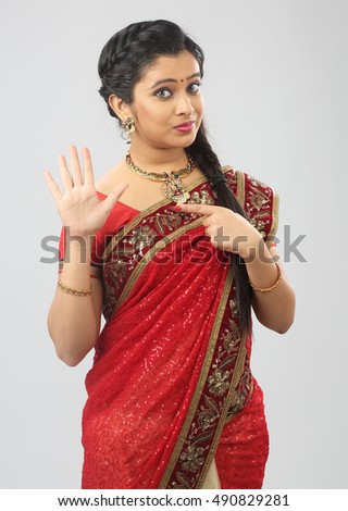 Indian woman showing gesturing on white background.

