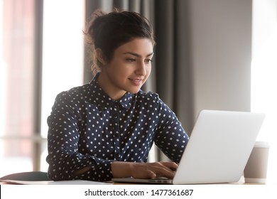 Indian Woman Sitting At Desk In Office Working On Laptop Typing Business E-mail, Check Media News, Solve Current Work-related Issues Distantly, Wireless Modern Tech Usage, Communication Online Concept