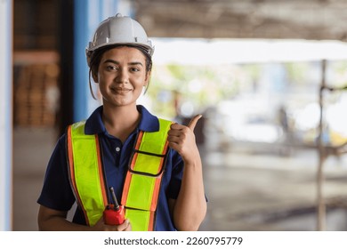 Indian woman staff worker engineer supervisor in safety suit work in factory warehouse - Powered by Shutterstock