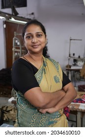 An Indian Woman Standing At Textile Factory