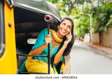 Indian Woman Talking On Phone In Rickshaw