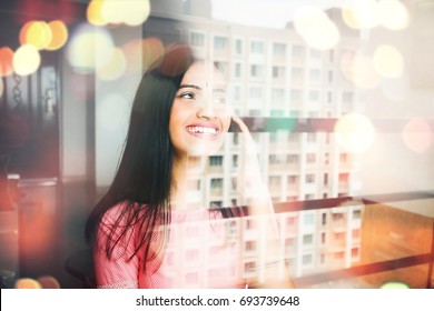 Indian Woman Talking On Phone Through The Window