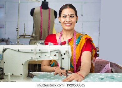 Indian Woman Textile Worker Using Sewing Machine On Production Line